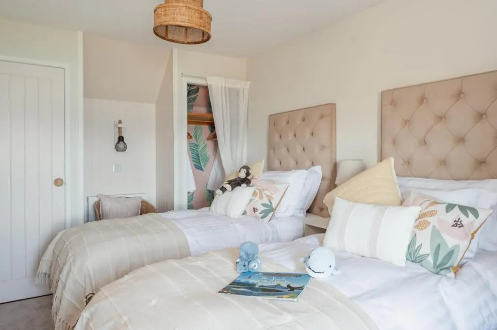 a bedroom with two beds with stuffed animals on them at Ina's Cottage - Seasgair Lodges in Portmahomack