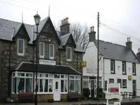 a group of buildings on a street in a town at Dunroamin Hotel in Bonar Bridge