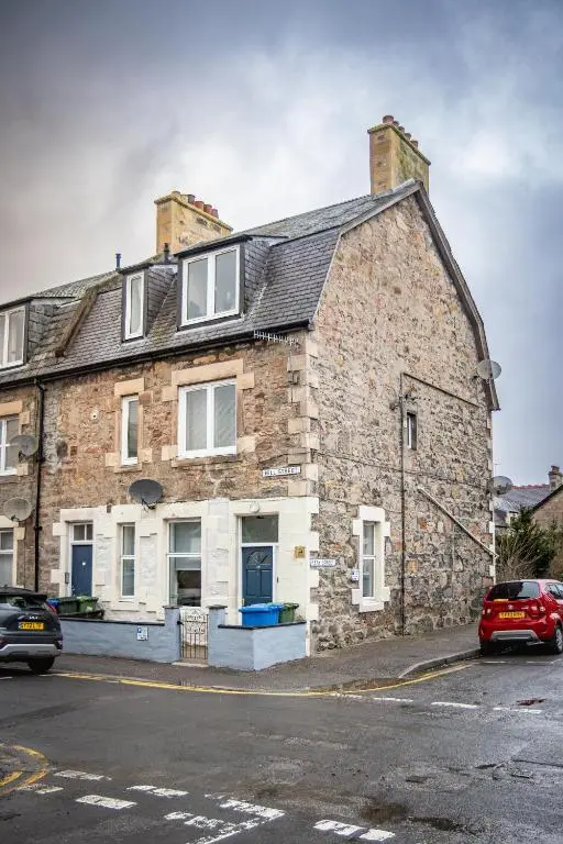 an old brick building on the side of a street at The Wee Gem in Inverness
