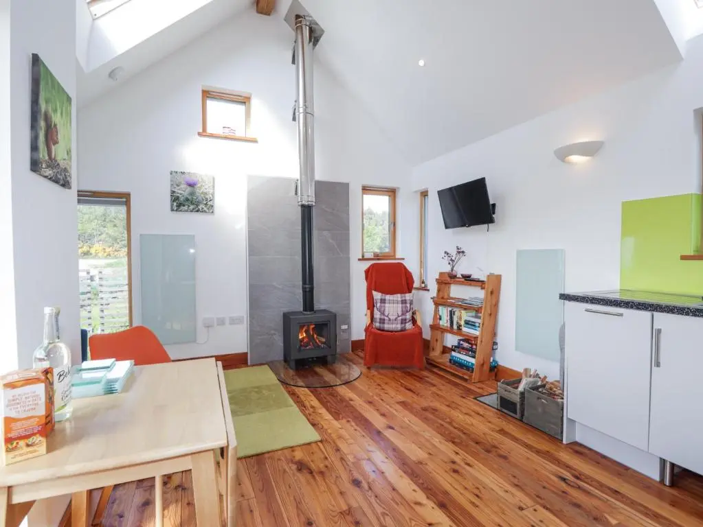 a kitchen and living room with a wood stove at Easter Blervie in Forres