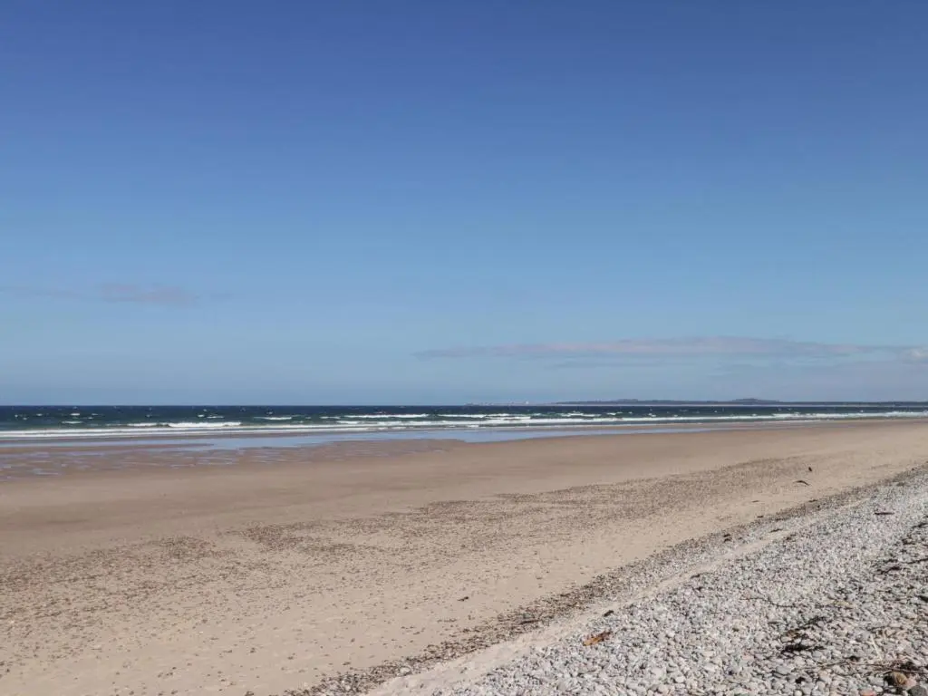 a sandy beach with the ocean in the background at Easter Blervie in Forres