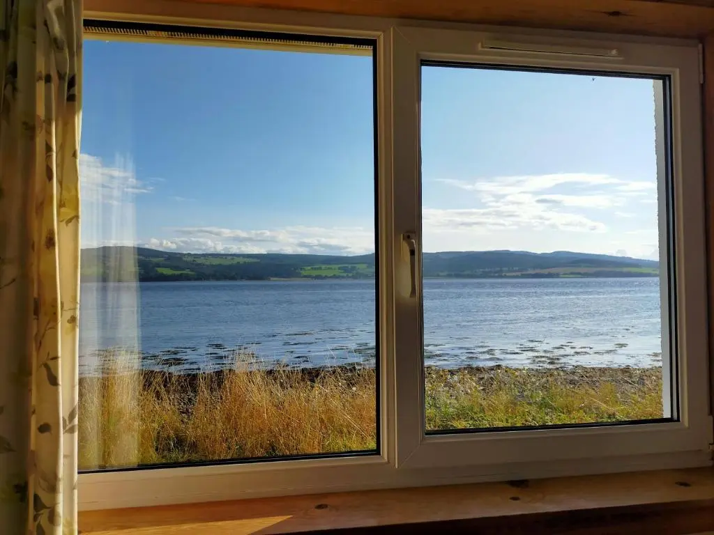 a window with a view of a body of water at Peaceful Sea View Home only 5 miles from Inverness in North Kessock