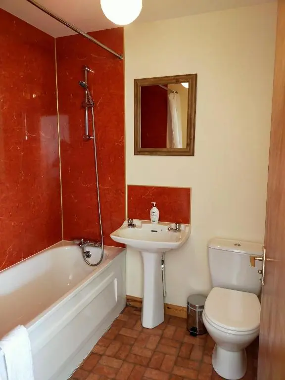 a bathroom with a sink and a toilet and a tub at Peaceful Sea View Home only 5 miles from Inverness in North Kessock