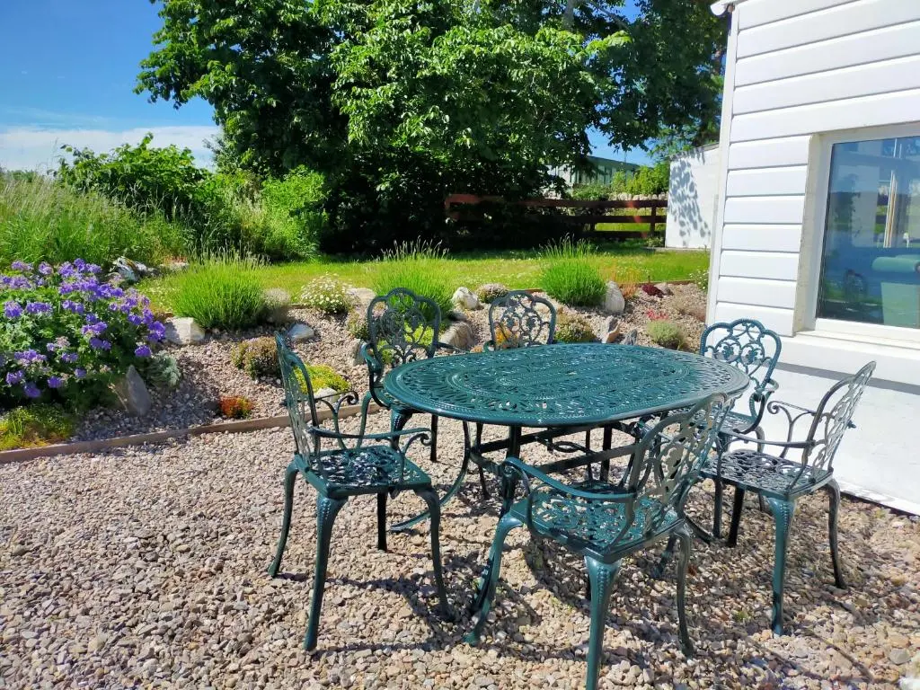 a table and chairs sitting in a gravel yard at Peaceful Sea View Home only 5 miles from Inverness in North Kessock