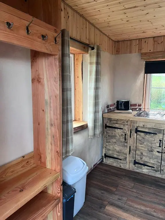 a bathroom with a toilet and a sink in a cabin at Willow Straw Bale Cabin
