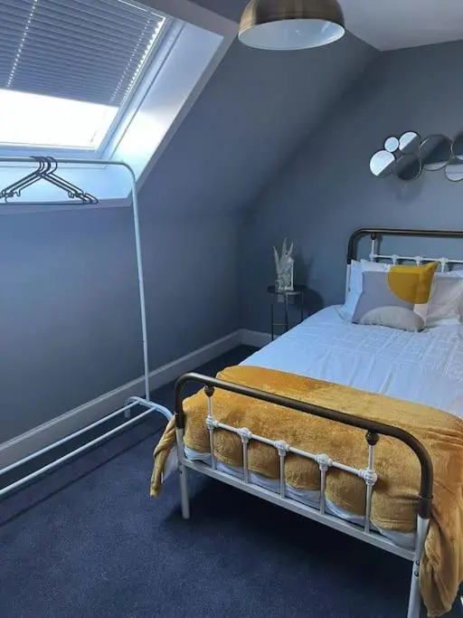 a bedroom with a bed in a blue room at GWR Dickson's House, NC500, Wick in Wick
