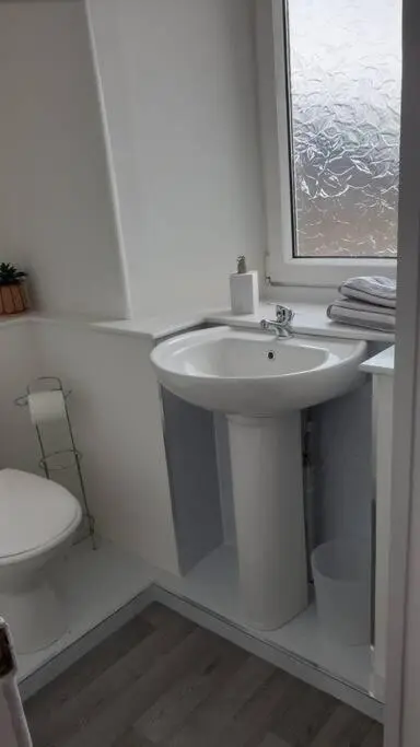 a white bathroom with a sink and a toilet at GWR Dickson's House, NC500, Wick in Wick