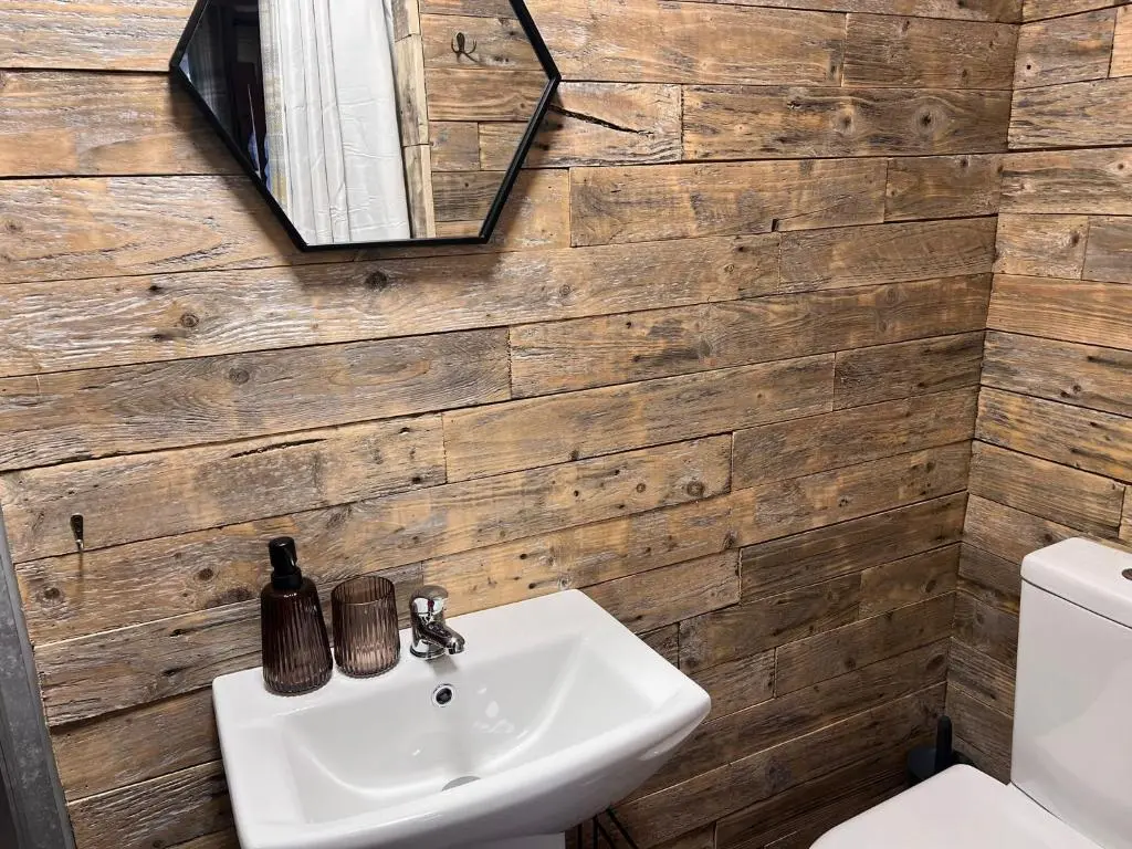 a bathroom with a sink and a toilet at Primrose Straw Bale Cabin