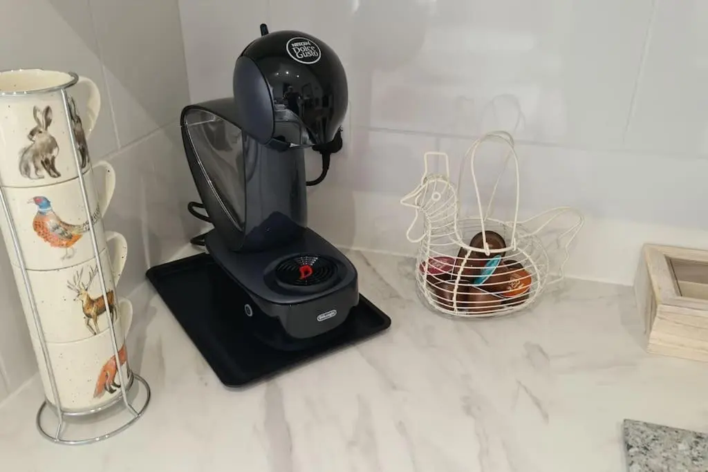 a black blender sitting on a counter with a basket at Northlea-Scottish style cottage in Inverness
