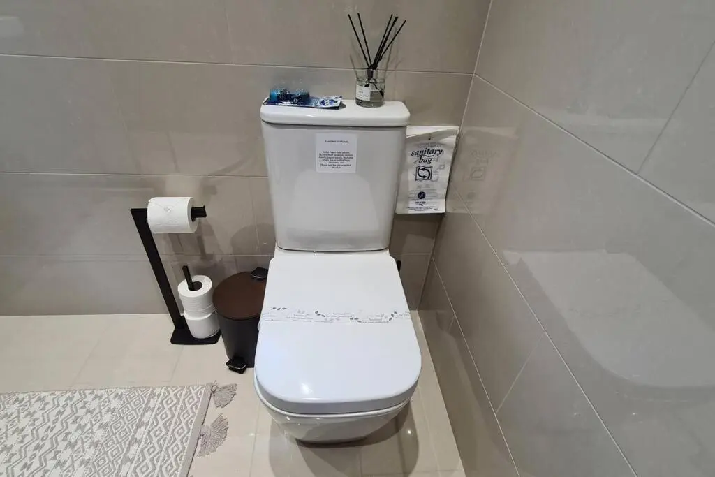 a bathroom with a white toilet in a room at Northlea-Scottish style cottage in Inverness