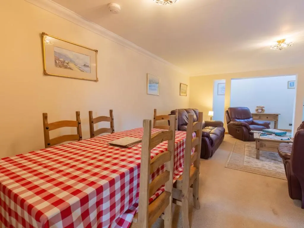 a kitchen and living room with a table and chairs at Holiday Home Lodge Road by Interhome in Inverness