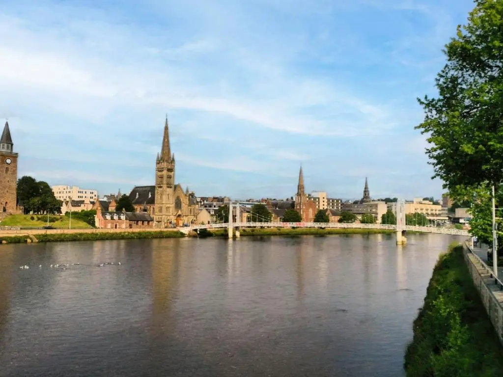 a bridge over a river in a city with buildings at Holiday Home Lodge Road by Interhome in Inverness