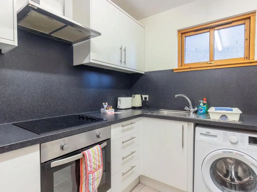 a kitchen with a sink and a washing machine at Apartment Towerhill Heights by Interhome in Inverness