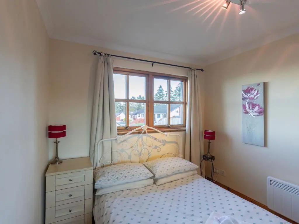 a bedroom with a bed and a window at Apartment Towerhill Heights by Interhome in Inverness