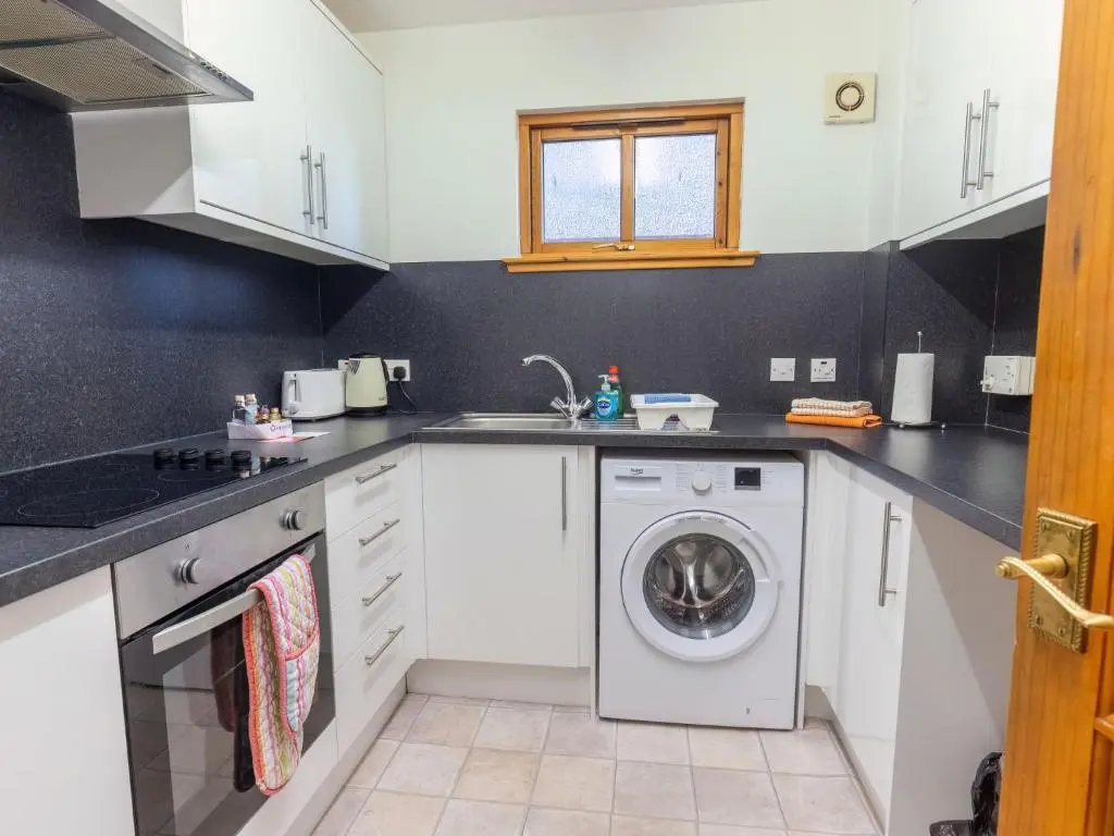 a kitchen with a washing machine and a sink at Apartment Towerhill Heights by Interhome in Inverness