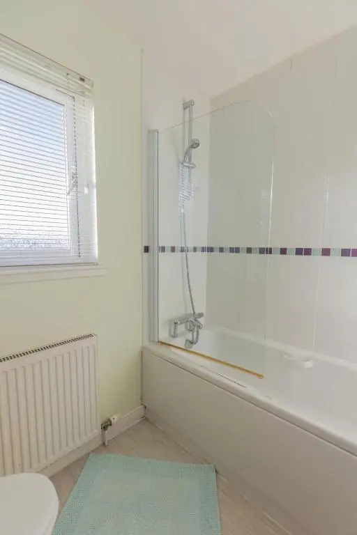 a bathroom with a shower and a blue rug at Apartment Ash House by Interhome in Inverness