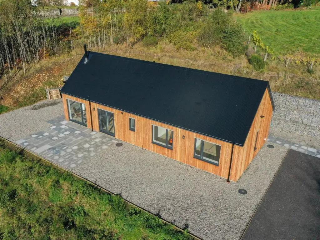 an overhead view of a house with a black roof at Holiday Home Loch View by Interhome in Balnain