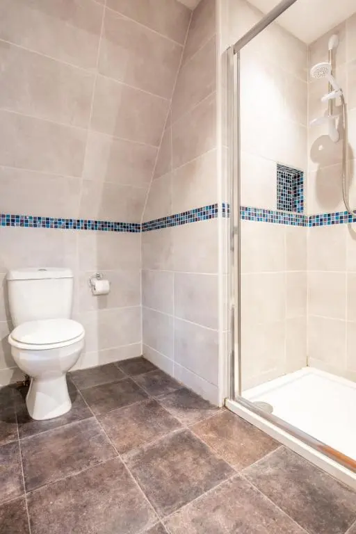 a bathroom with a toilet and a shower at Chalet Lothlorien Lodge 4 by Interhome in Spean Bridge