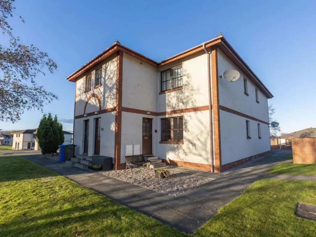 a large white house with a grass yard at Apartment Miller Heights by Interhome in Inverness