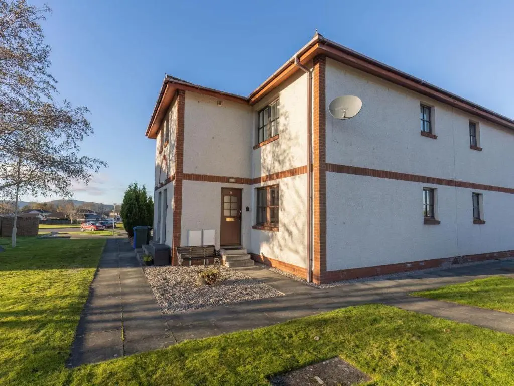 a large white building with a grass yard at Apartment Miller Heights by Interhome in Inverness