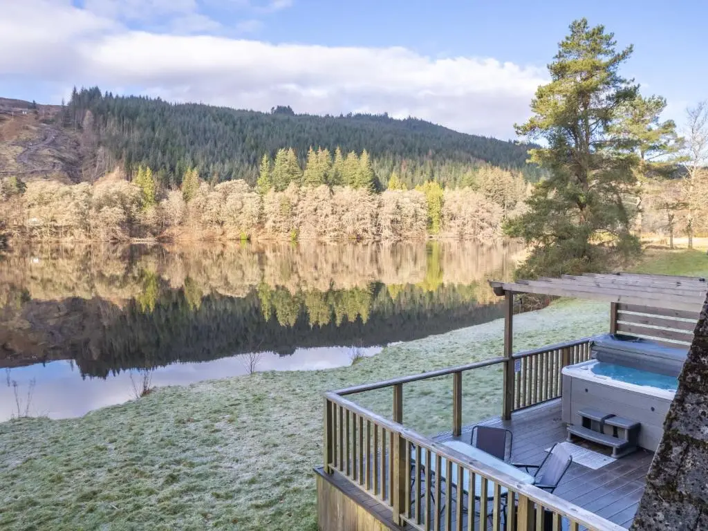 a deck with a view of a lake at Chalet Woodhaven by Interhome in Spean Bridge