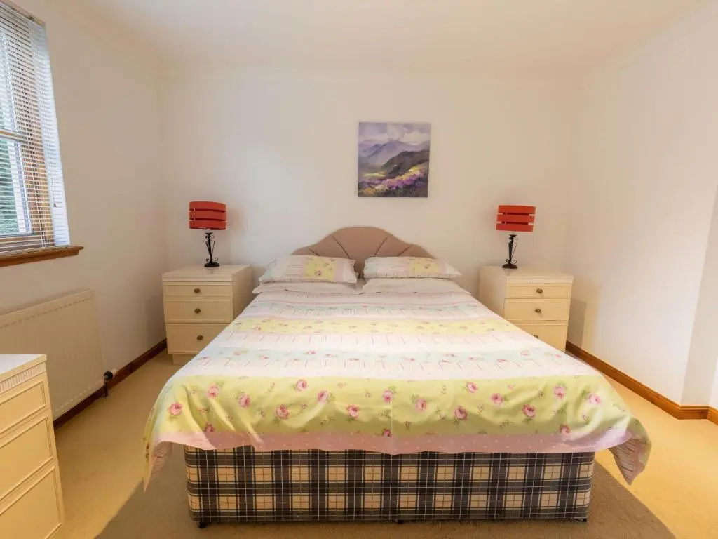 a bedroom with a bed and two night stands at Apartment Elm Grove by Interhome in Inverness