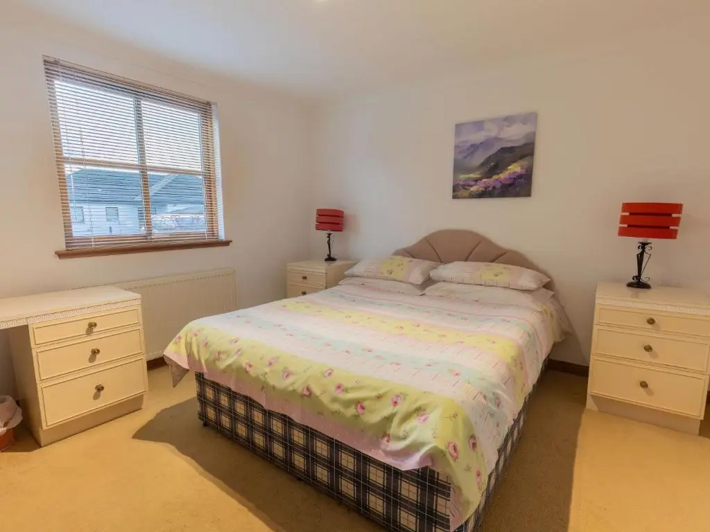 a bedroom with a bed and two night stands at Apartment Elm Grove by Interhome in Inverness