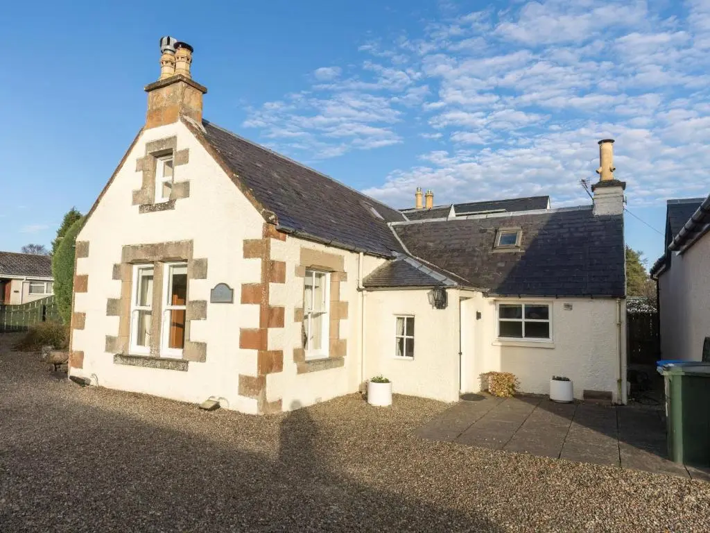 a white house with a black roof at Holiday Home Old Lodge by Interhome in Inverness
