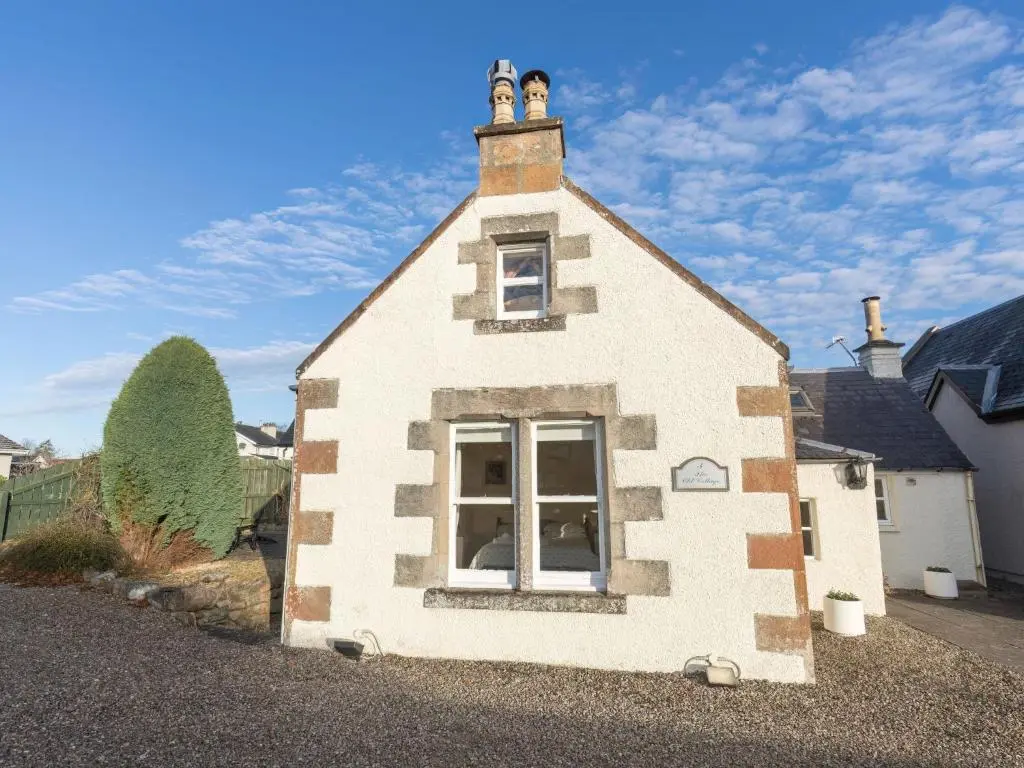 a small white building with a window on it at Holiday Home Old Lodge by Interhome in Inverness