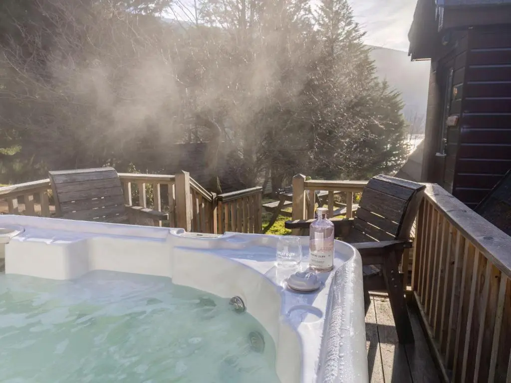 a hot tub with a bottle of water on a deck at Chalet Rivendell by Interhome in Spean Bridge