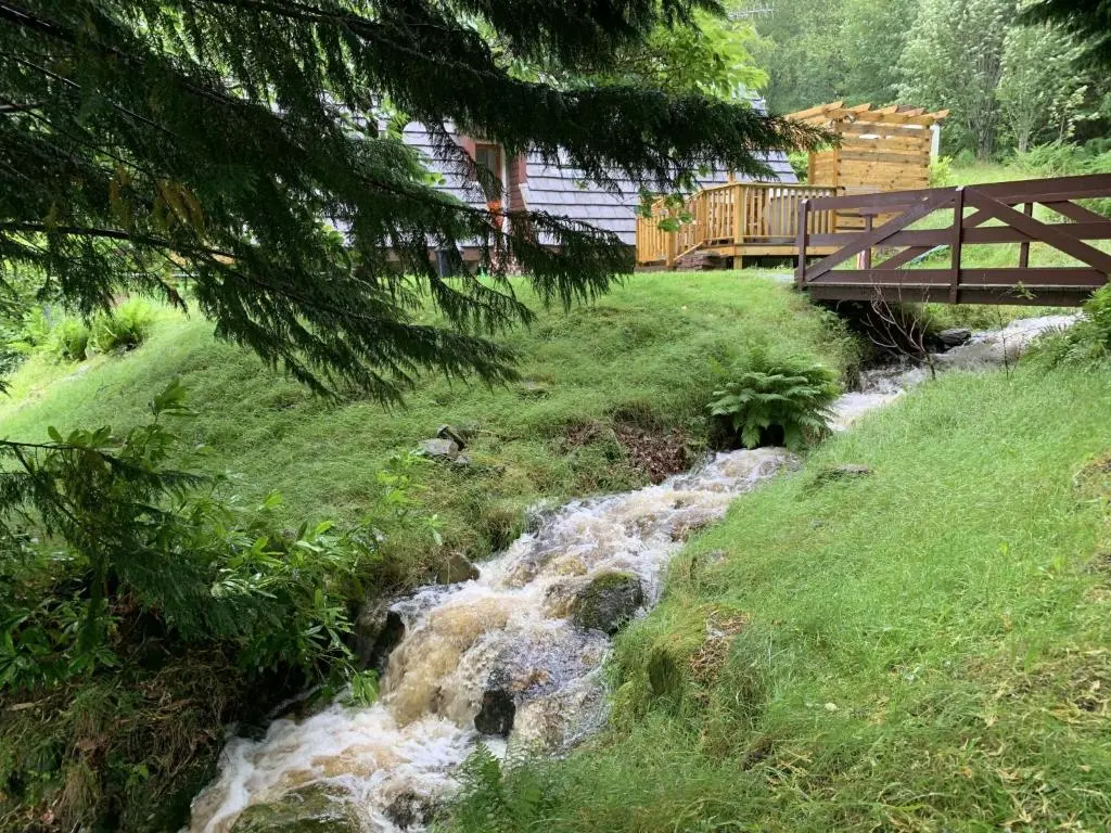 a stream of water with a bridge over it at Chalet Rivendell by Interhome in Spean Bridge