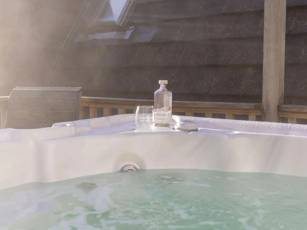 a bottle of water sitting on top of a bath tub at Chalet Rivendell by Interhome in Spean Bridge