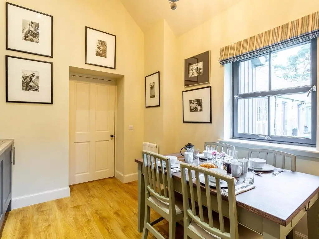 a dining room with a table and chairs and a window at 1 Bed in Forres 78430 in Forres