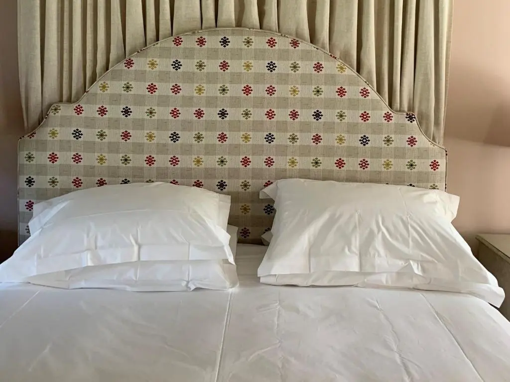 a bed with two pillows in front of a wall at 1 Bed in Forres 78430 in Forres