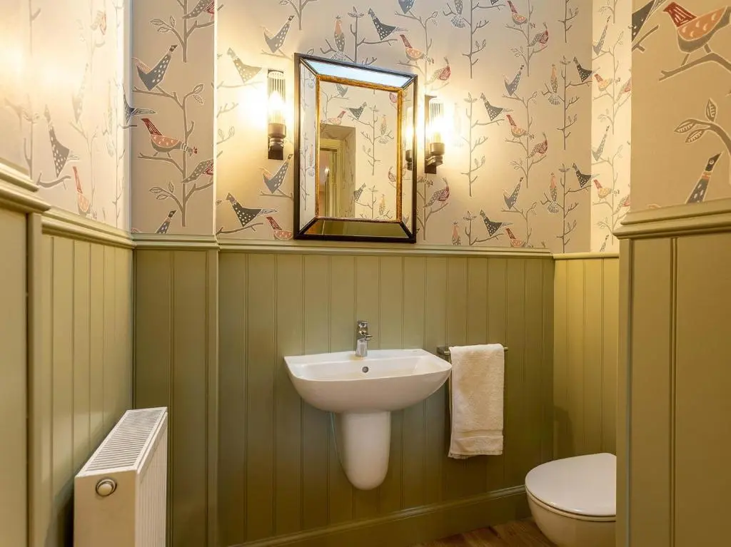 a bathroom with a sink and a toilet and a mirror at 1 Bed in Forres 78430 in Forres