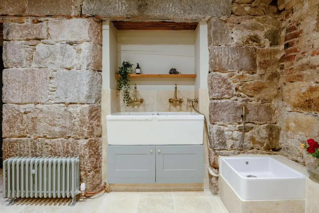 a bathroom with a sink and a bath tub at Manar House Ground Floor Luxury Apartment in Inverurie