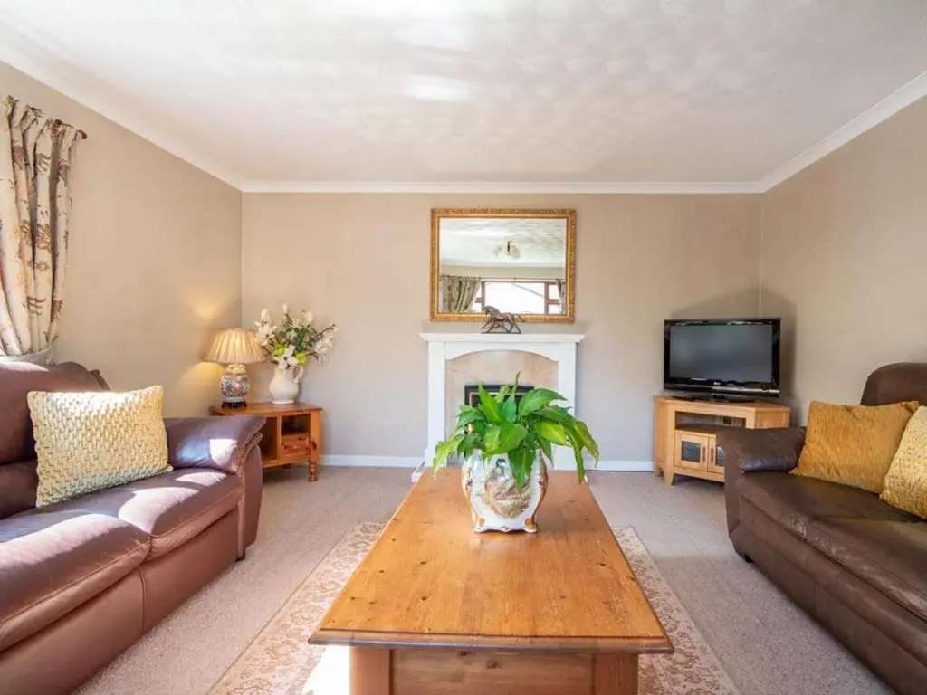 a living room with a couch and a table at Black Rock Cottage in Culbokie
