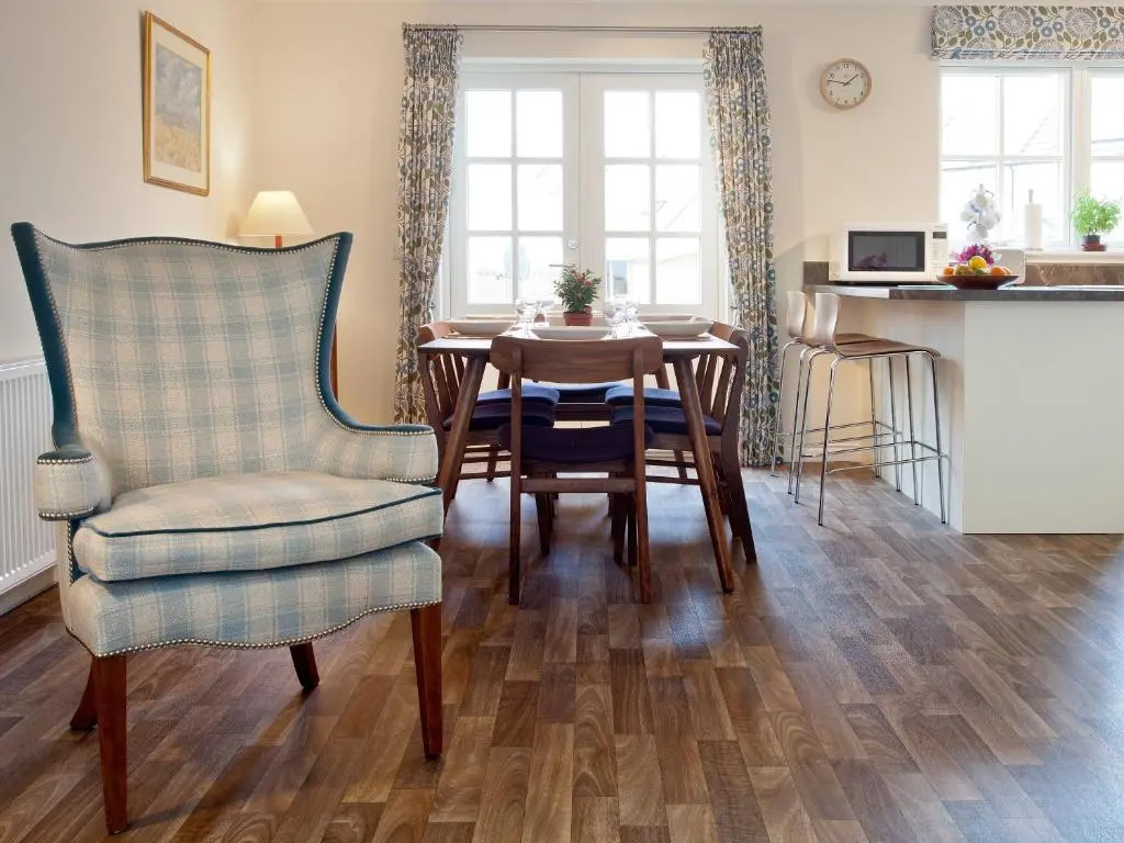 a living room with a table and a chair at Mackay Road - Uk7451 in Dornoch