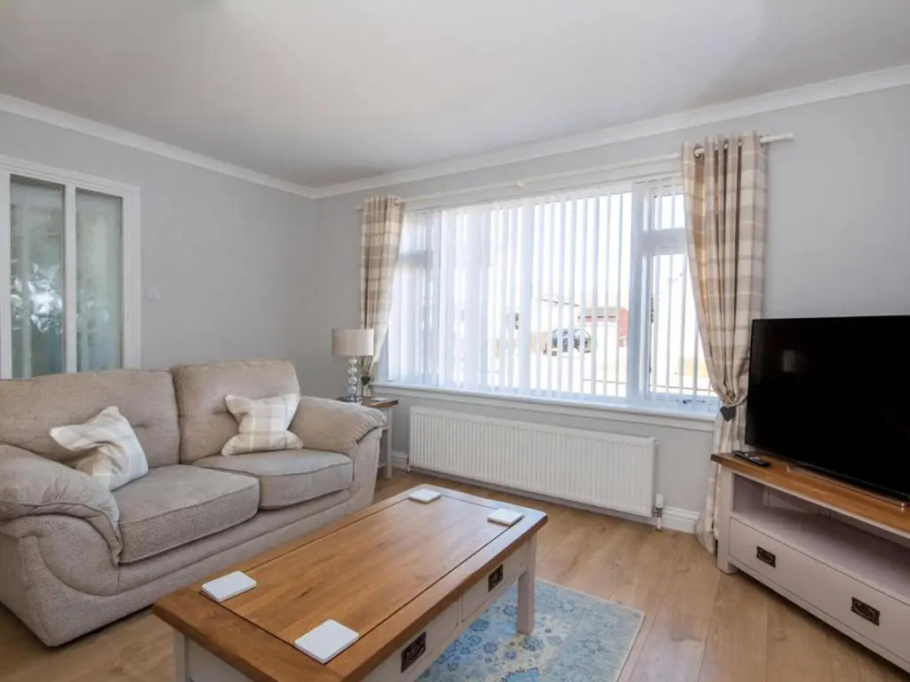 a living room with a couch and a coffee table at Raasay in Dornoch