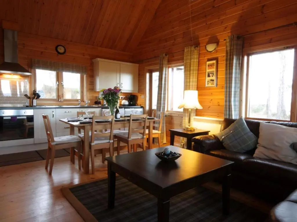 a living room with a couch and a table at Taigh Fiodha in Balintore