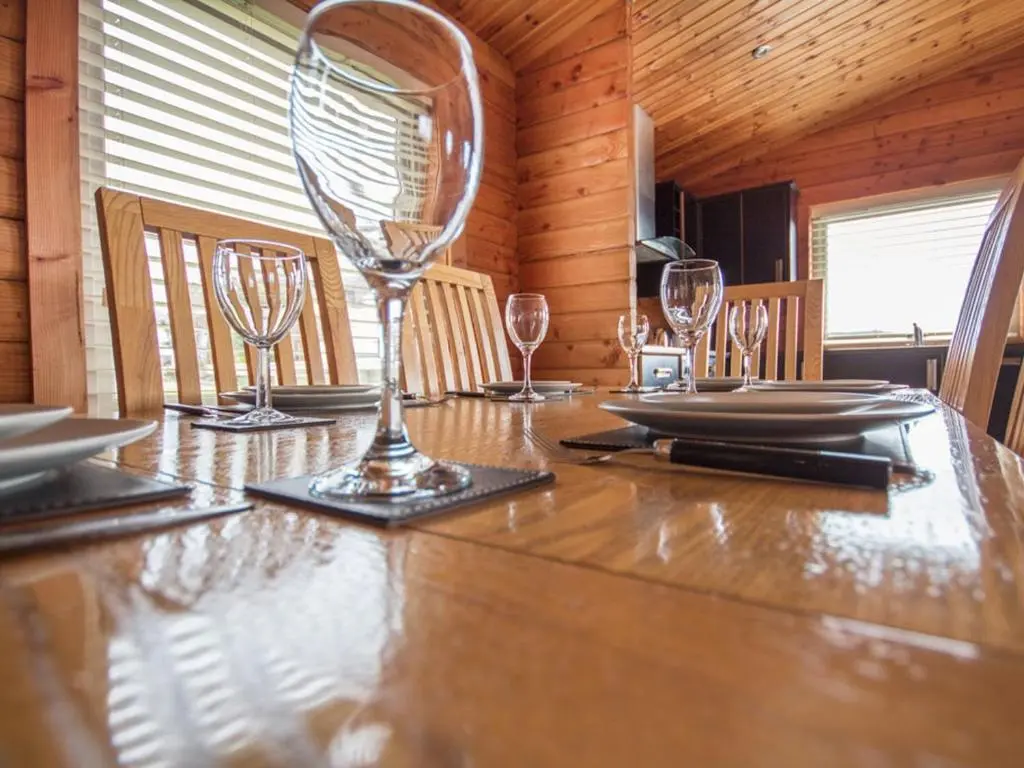 a dining room table with wine glasses on it at Gael Cham in Aviemore
