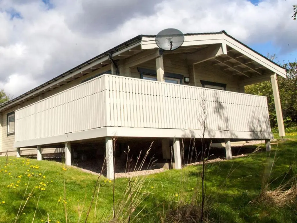 a house with a clock on the front of it at Carn Eilrig in Aviemore