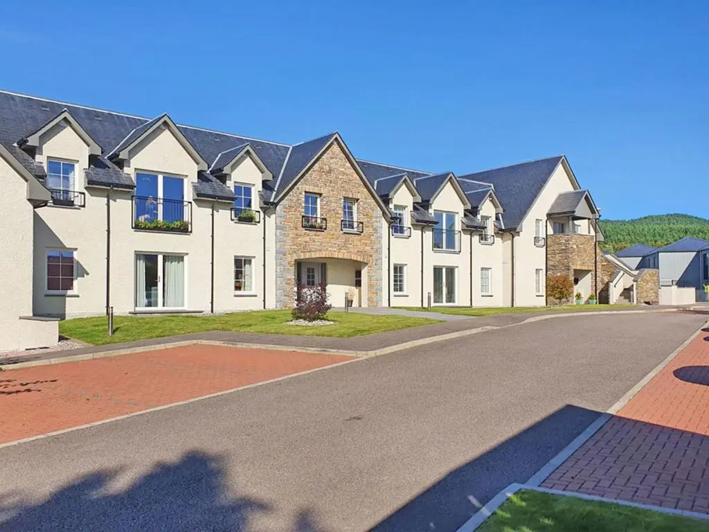 a row of houses on a street at The Steading Apartment, No9 in Aviemore