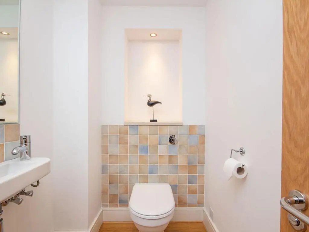a bathroom with a toilet and a sink at 208 By The Bridge Apartment in Inverness