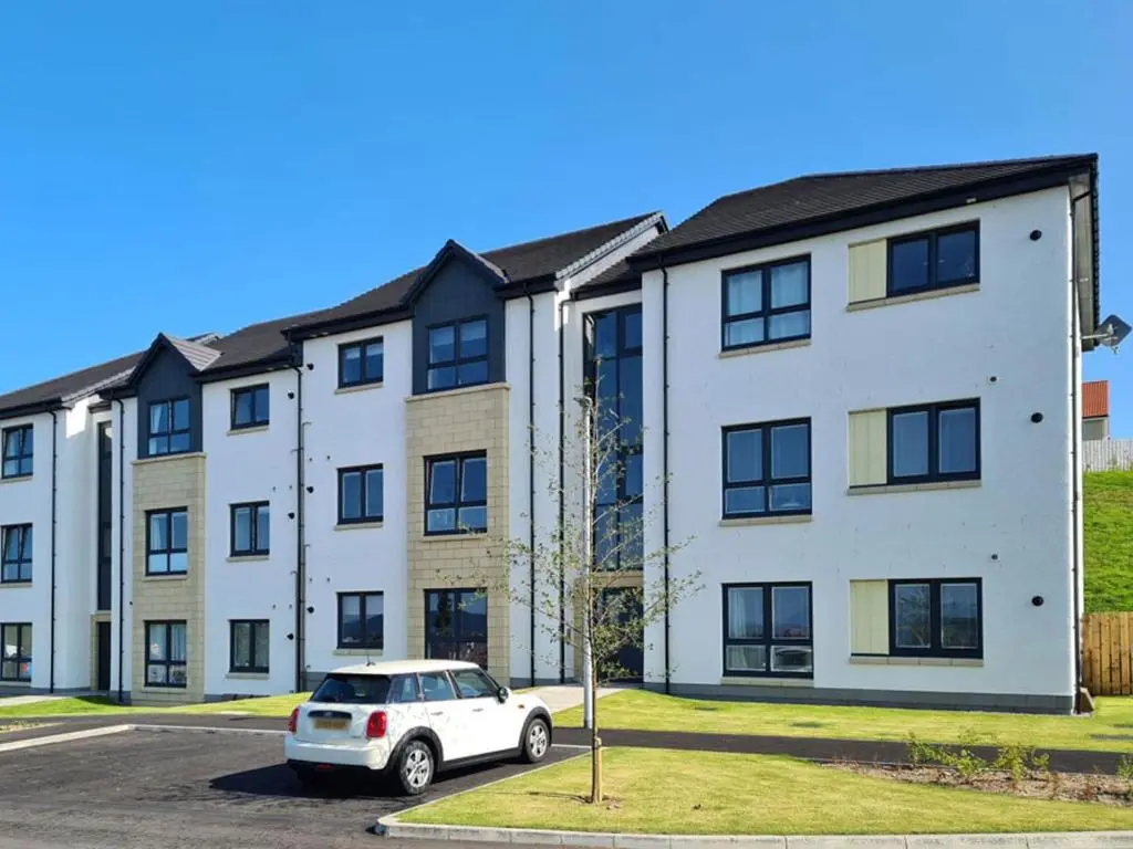 a white car parked in front of a building at Kessock View Apartment in Inshes