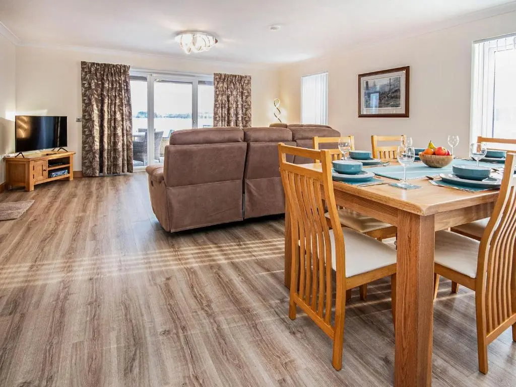 a living room with a table and a couch at Terra Verde in Beauly