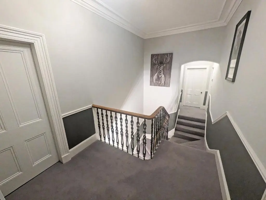 a staircase in a house with a stair case at Reay House in Nairn
