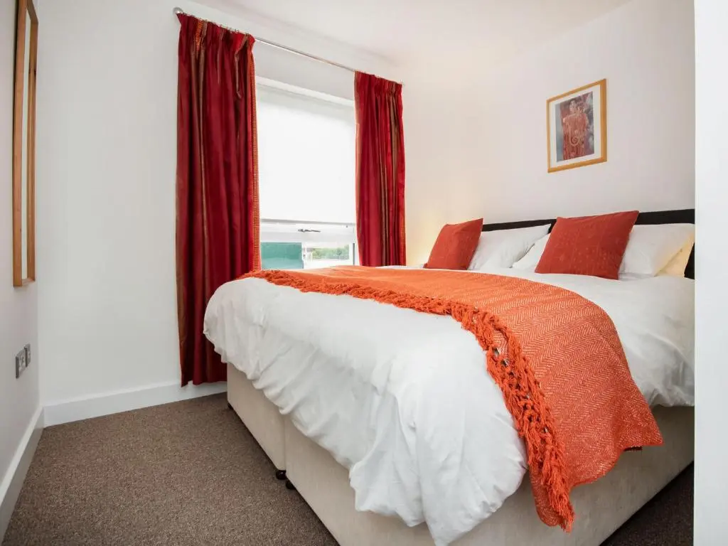 a bedroom with a bed and a window at Thistledown in Dornoch