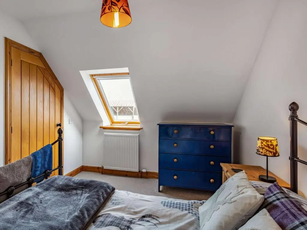 a bedroom with a bed and a blue dresser at 3 Bed in Huntly 57368 in Insch