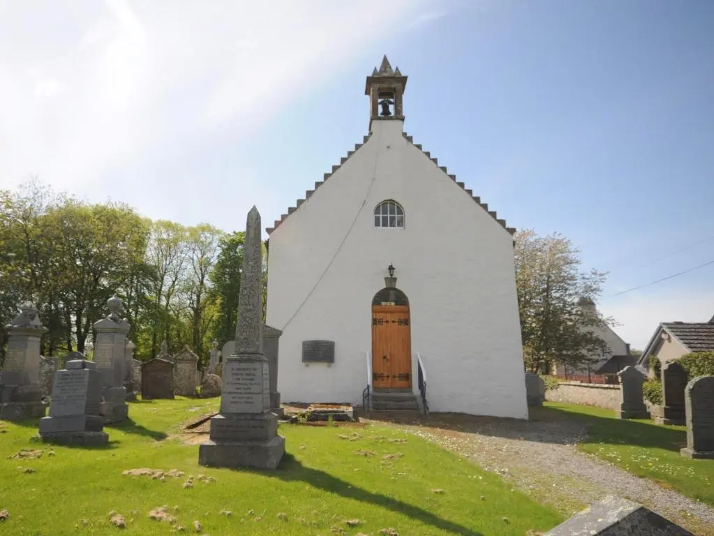 a small white church with a steeple and a door at 3 Bed in Huntly 57368 in Insch